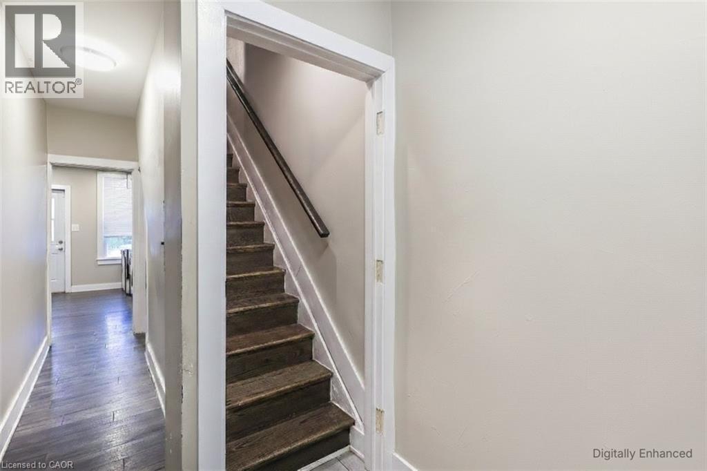 Staircase with wood finished floors and baseboards - 27 Ashley Street, Hamilton, ON - Indoor Photo Showing Other Room