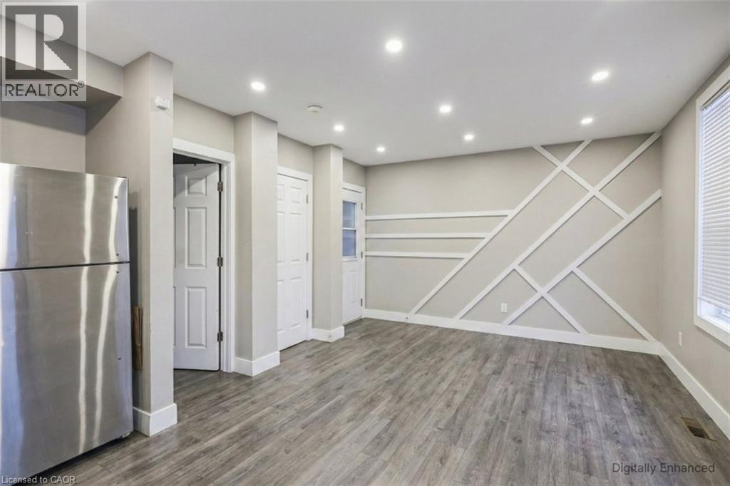 Unfurnished dining area with dark wood-style flooring and recessed lighting - 27 Ashley Street, Hamilton, ON - Indoor