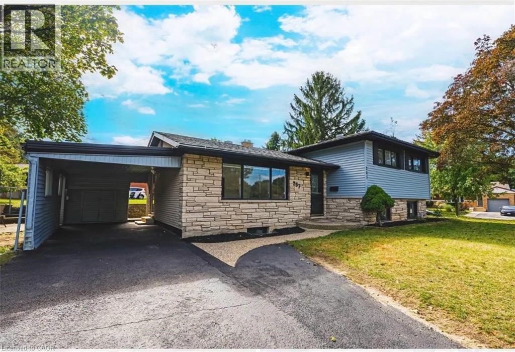 Tri-level home with stone siding, a front lawn, a carport, and driveway - 267 Erb Street E, Waterloo, ON - Outdoor