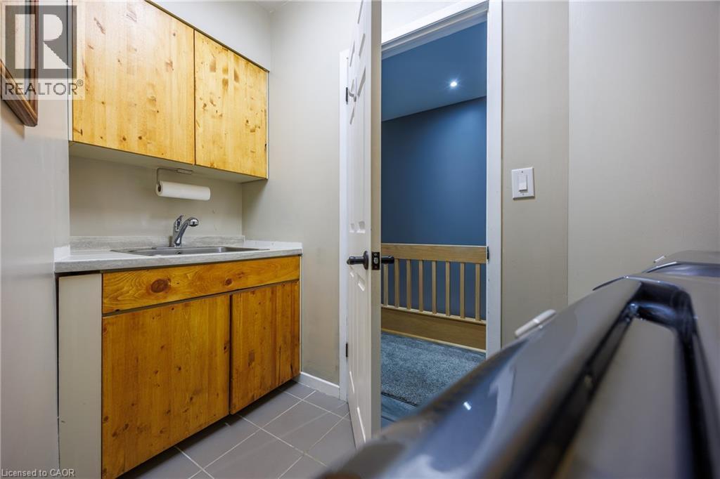 countertops and dark tile patterned flooring - 1285 Cockshutt Road, Simcoe, ON - Indoor Photo Showing Other Room