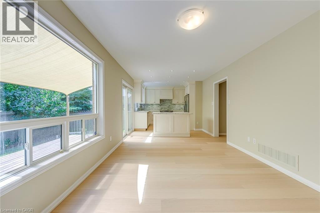 Family room with light wood-style floors and baseboards - 3037 Abernathy Way, Oakville, ON - Indoor Photo Showing Other Room