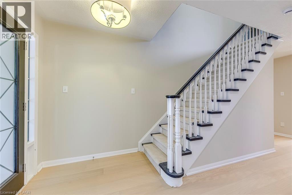 Foyer with light wood finished floors and stairs - 3037 Abernathy Way, Oakville, ON - Indoor Photo Showing Other Room