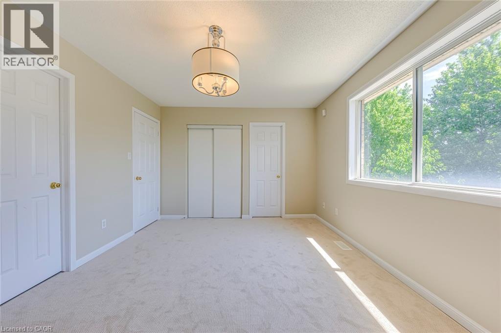 Primary bedroom with light carpet and a closet - 3037 Abernathy Way, Oakville, ON - Indoor Photo Showing Other Room