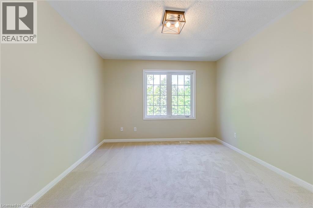 Bedroom 3 featuring light colored carpet and a textured ceiling - 3037 Abernathy Way, Oakville, ON - Indoor Photo Showing Other Room