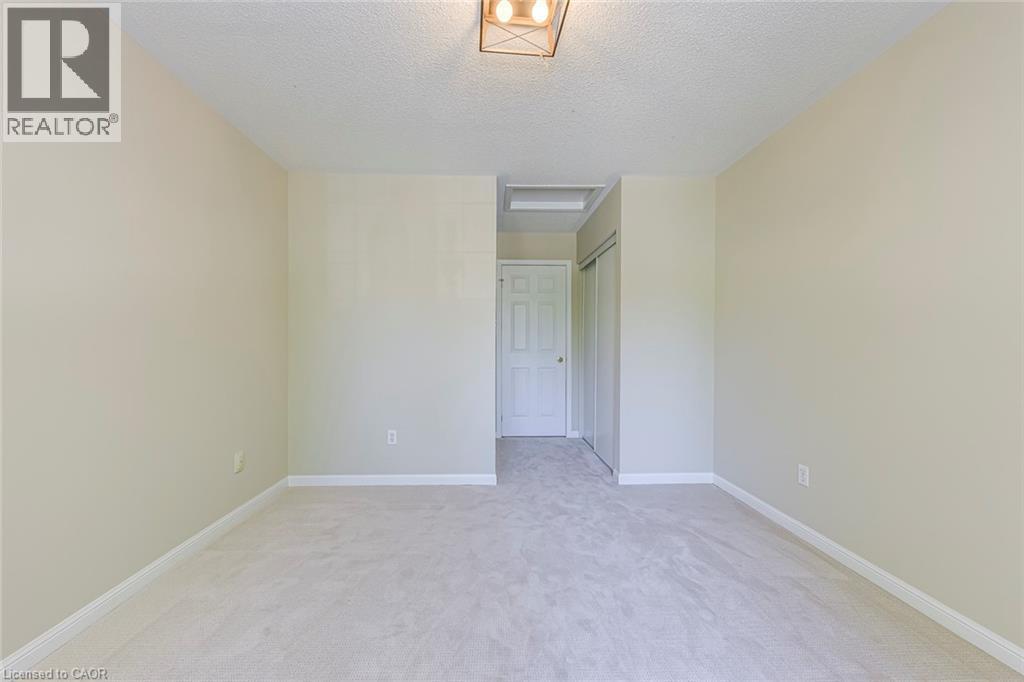 Bedroom 3 featuring light colored carpet and a textured ceiling - 3037 Abernathy Way, Oakville, ON - Indoor Photo Showing Other Room