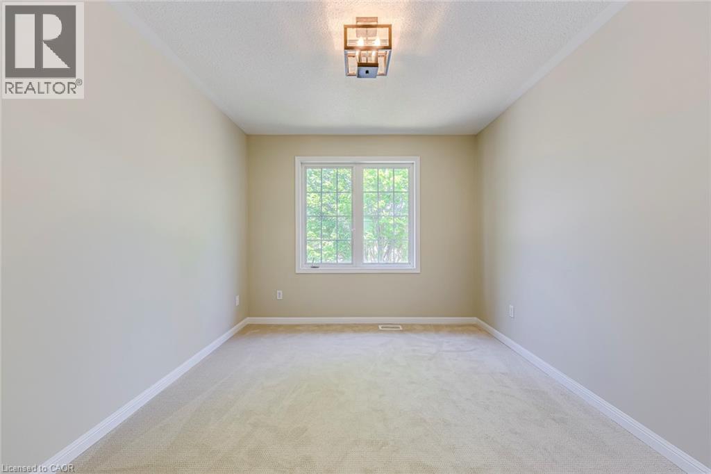 Bedroom 4 with light colored carpet and a textured ceiling - 3037 Abernathy Way, Oakville, ON - Indoor Photo Showing Other Room