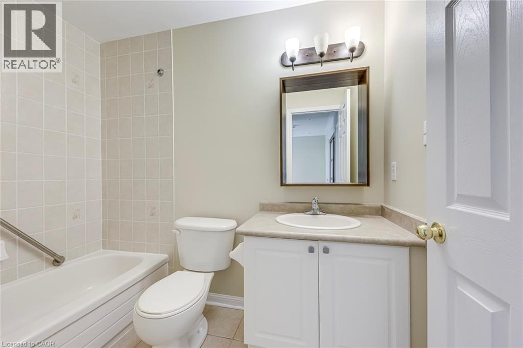 Bathroom with vanity, bathing tub / shower combination, and light tile patterned floors - 3037 Abernathy Way, Oakville, ON - Indoor Photo Showing Bathroom