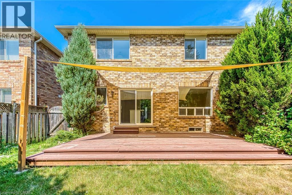 Rear view of house with brick siding and a deck - 3037 Abernathy Way, Oakville, ON - Outdoor