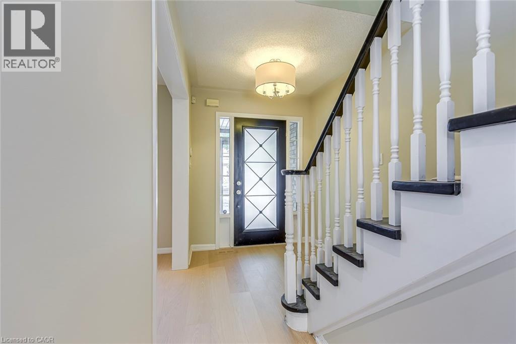 Entryway featuring light wood-style floors and a textured ceiling - 3037 Abernathy Way, Oakville, ON - Indoor Photo Showing Other Room