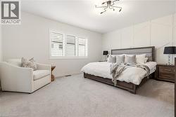 Bedroom featuring carpet floors and baseboards -