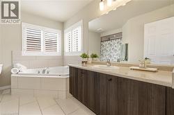 Full bath with a shower with curtain, vanity, a garden tub, and light tile patterned floors -