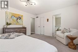 Carpeted bedroom with baseboards and ensuite bathroom -