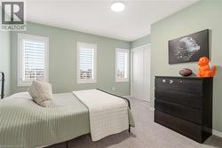 Bedroom featuring carpet flooring and a closet -