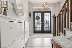 Entrance foyer featuring french doors and hanging lights -