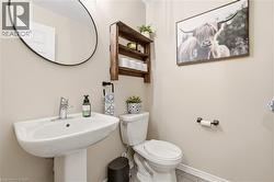 Half bathroom featuring toilet and baseboards -