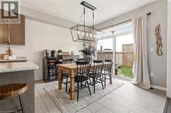 Dining space featuring suspended lighting and light tile patterned floors -