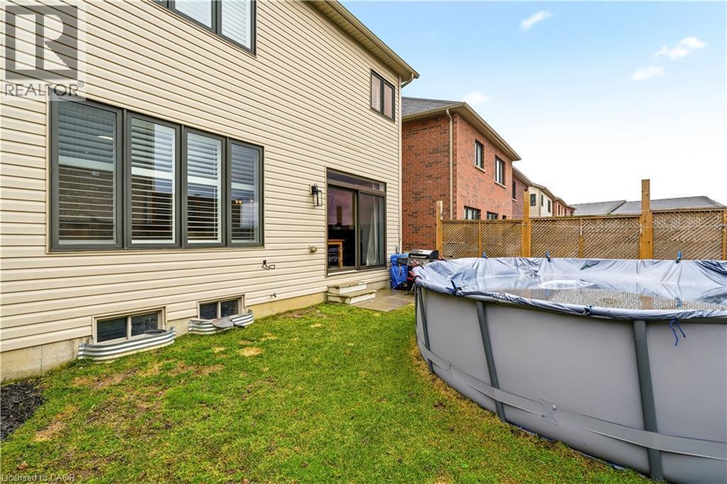 Rear view of property featuring a covered pool and entry steps - 105 Larry Crescent, Caledonia, ON - Outdoor With Above Ground Pool With Exterior