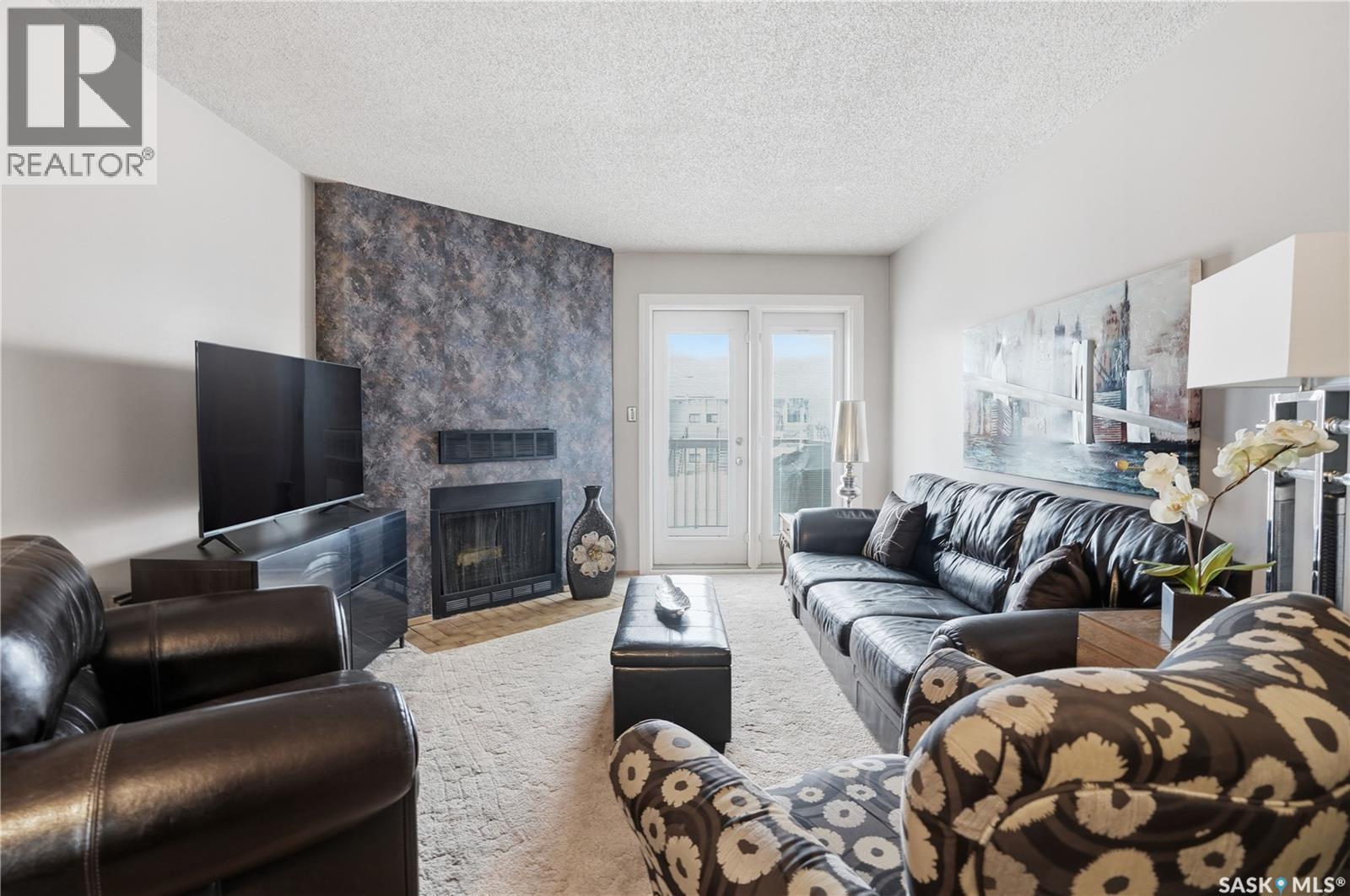 118 Cedar Meadow Drive, Regina, SK - Indoor Photo Showing Living Room With Fireplace