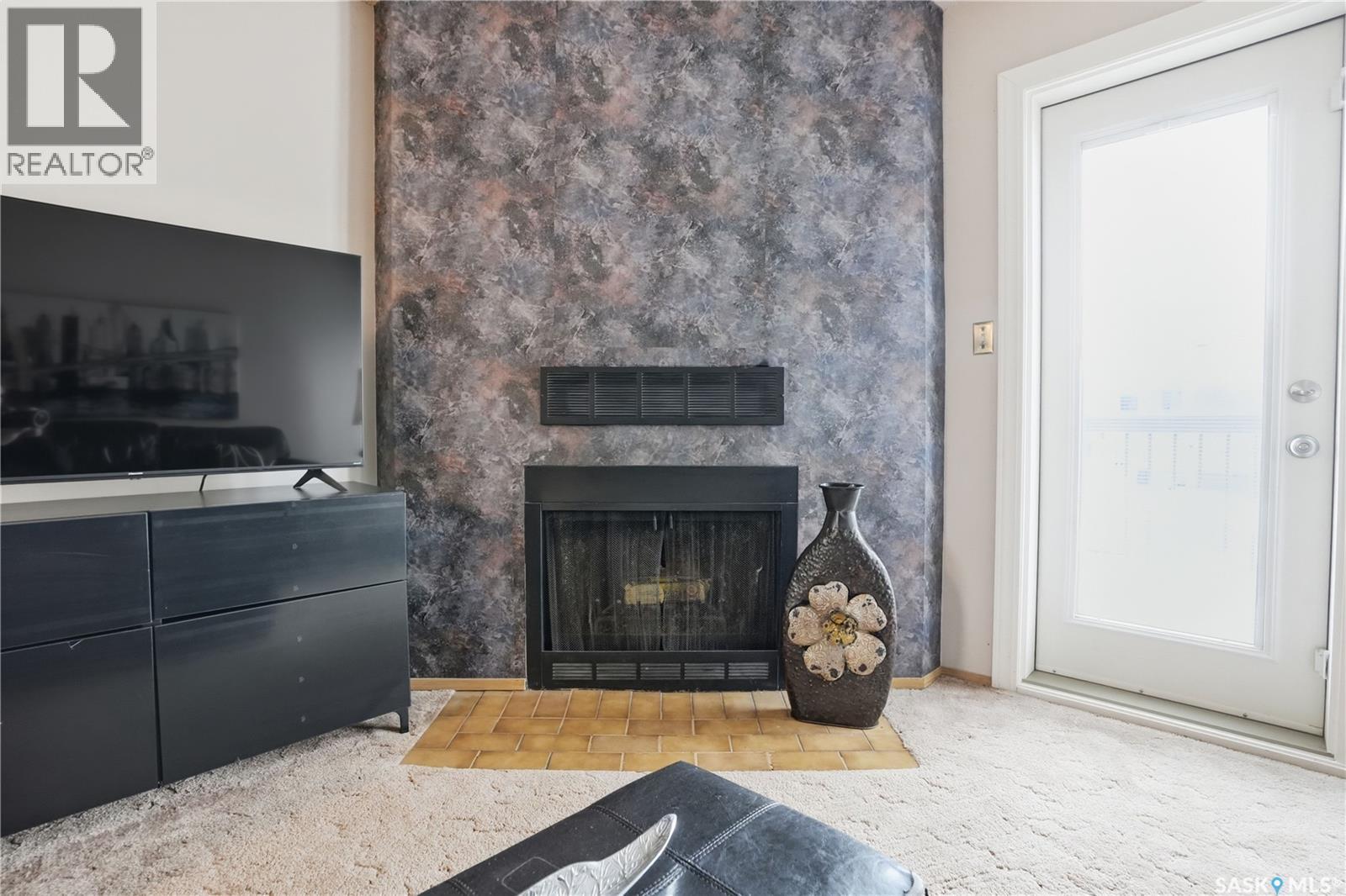 118 Cedar Meadow Drive, Regina, SK - Indoor Photo Showing Living Room With Fireplace