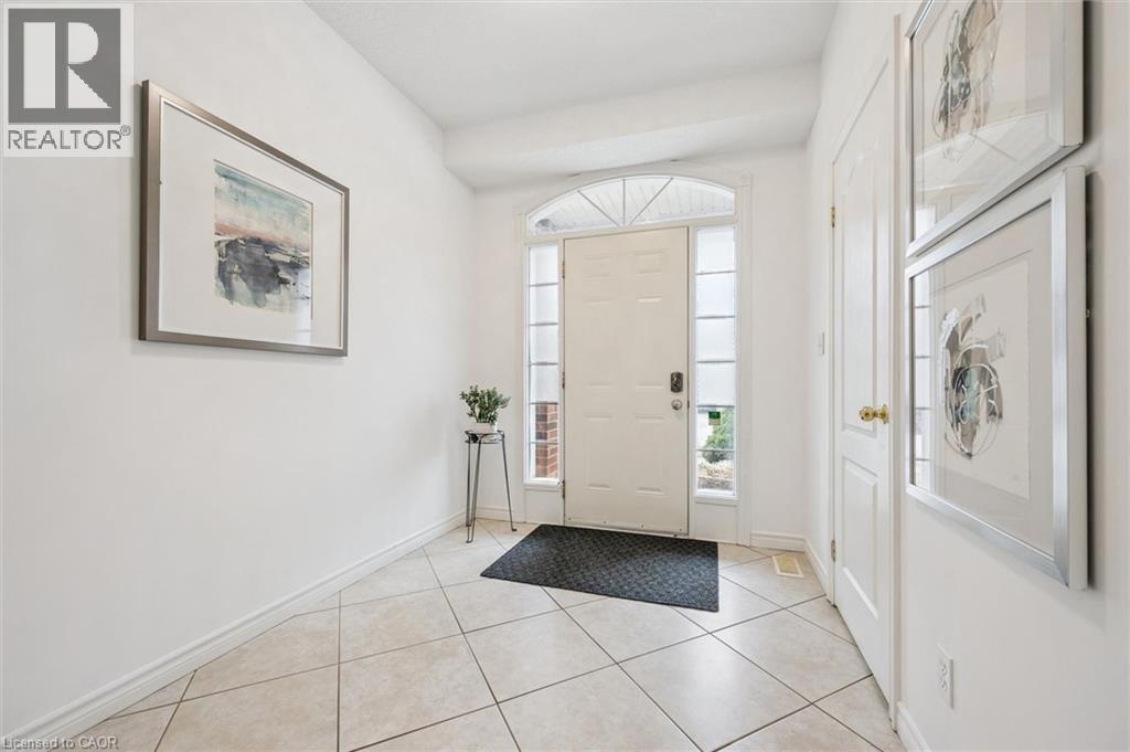 Entryway featuring baseboards and light tile patterned flooring - 512 Wood Nettle Way, Waterloo, ON - Indoor Photo Showing Other Room