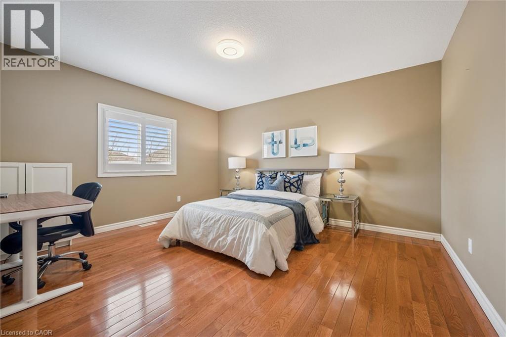 Bedroom featuring light wood-style flooring and an office area - 512 Wood Nettle Way, Waterloo, ON - Indoor Photo Showing Bedroom