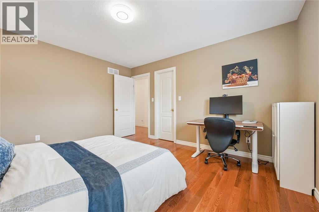 Bedroom featuring light wood-style floors and a desk - 512 Wood Nettle Way, Waterloo, ON - Indoor Photo Showing Bedroom
