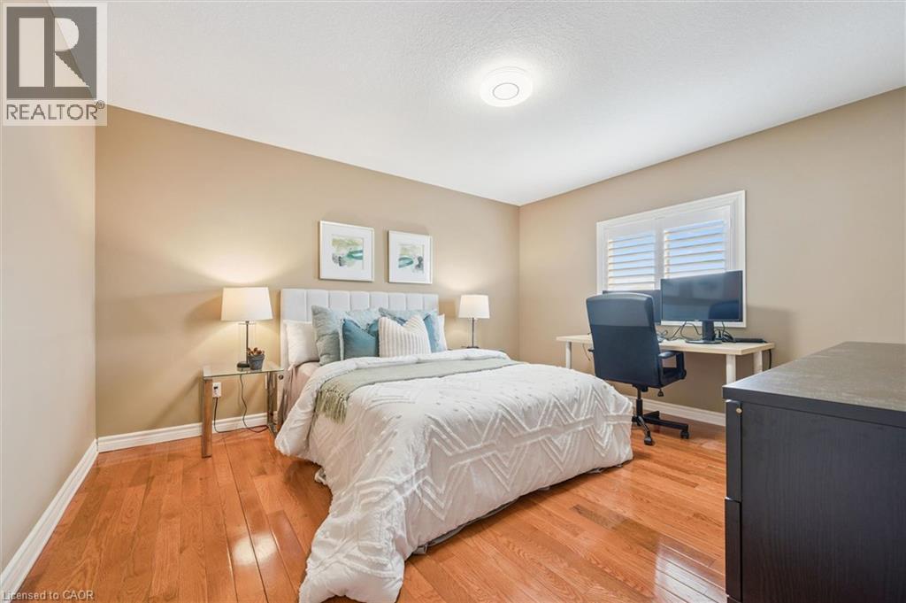 Bedroom with light wood finished floors and a desk - 512 Wood Nettle Way, Waterloo, ON - Indoor Photo Showing Bedroom