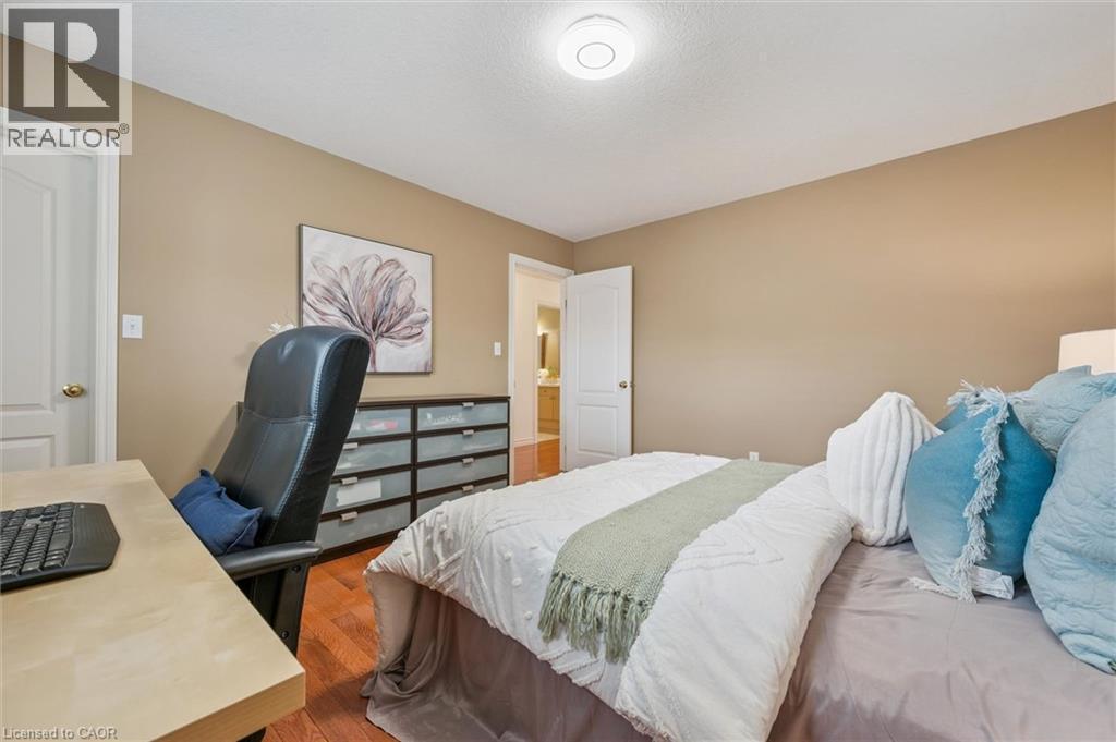 Bedroom with wood finished floors and an office area - 512 Wood Nettle Way, Waterloo, ON - Indoor Photo Showing Bedroom