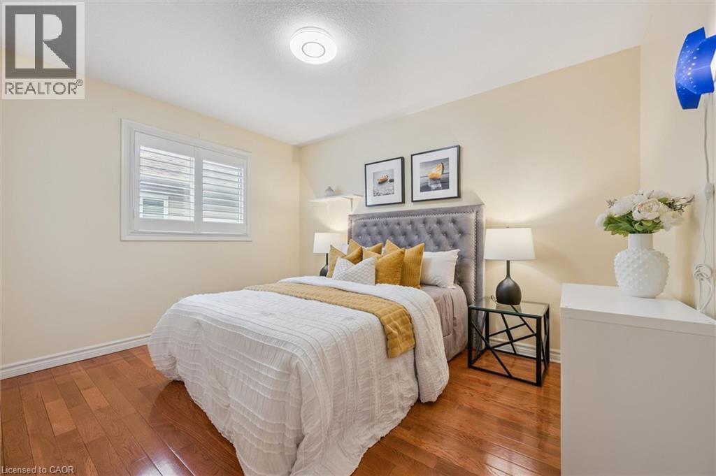 Bedroom with wood-type flooring and baseboards - 512 Wood Nettle Way, Waterloo, ON - Indoor Photo Showing Bedroom