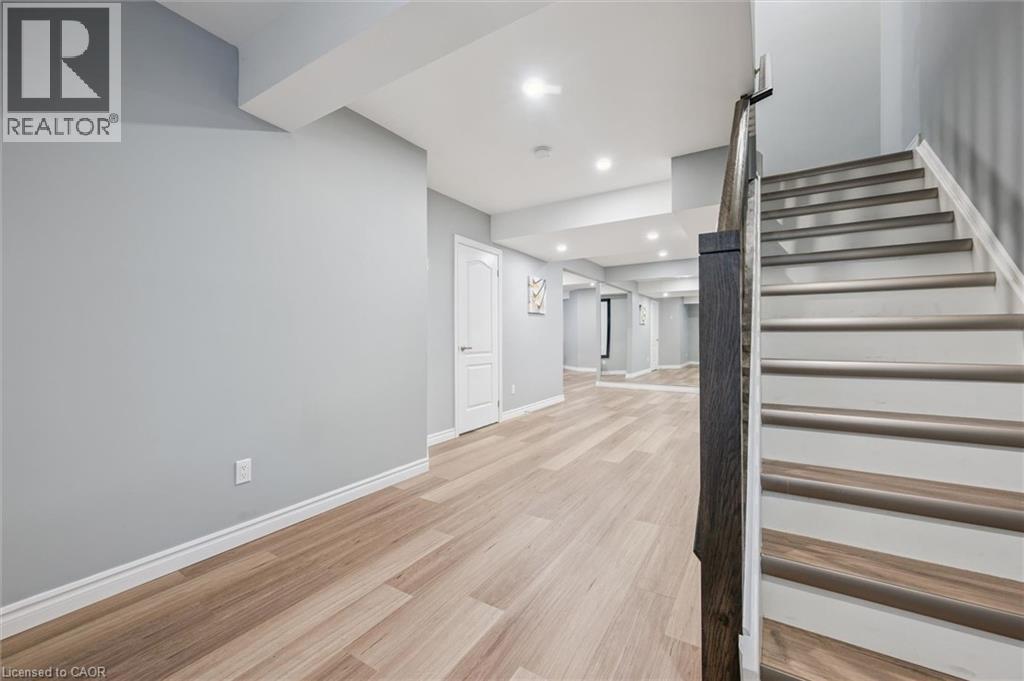 Stairs with wood finished floors and recessed lighting - 512 Wood Nettle Way, Waterloo, ON - Indoor Photo Showing Other Room