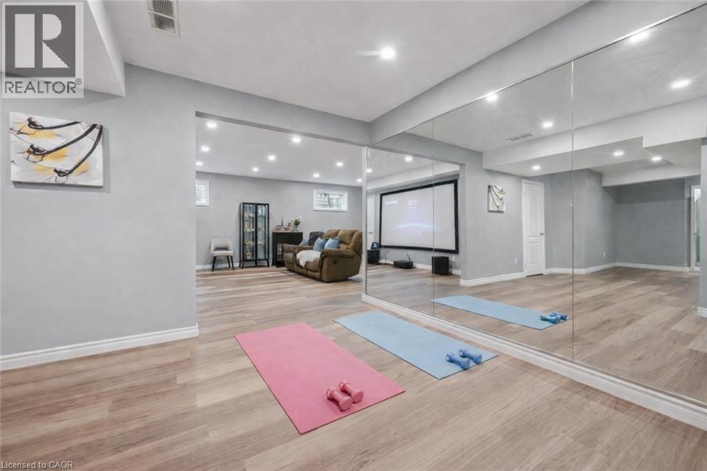 Exercise room featuring light wood-type flooring and recessed lighting - 512 Wood Nettle Way, Waterloo, ON - Indoor Photo Showing Other Room