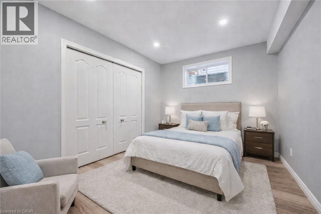 Bedroom featuring light wood-style flooring, a closet, and recessed lighting - 512 Wood Nettle Way, Waterloo, ON - Indoor Photo Showing Bedroom