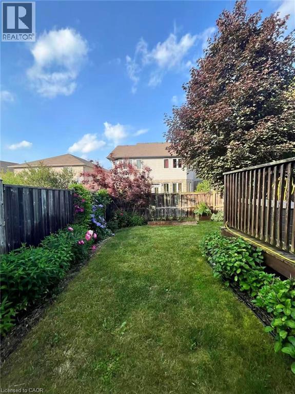 View of fenced backyard - 512 Wood Nettle Way, Waterloo, ON - Outdoor With Deck Patio Veranda