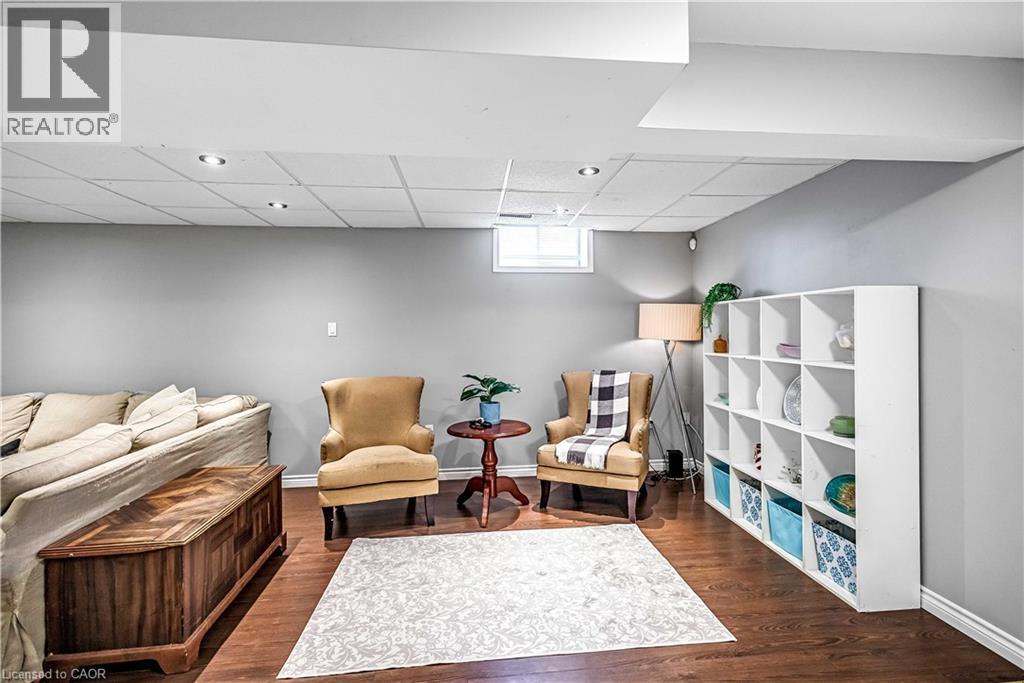 Sitting room with a drop ceiling and dark wood finished floors - 65 Thistlemoor Drive, Caledonia, ON - Indoor