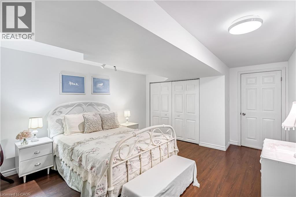 Bedroom with dark wood-style floors and a closet - 65 Thistlemoor Drive, Caledonia, ON - Indoor Photo Showing Bedroom