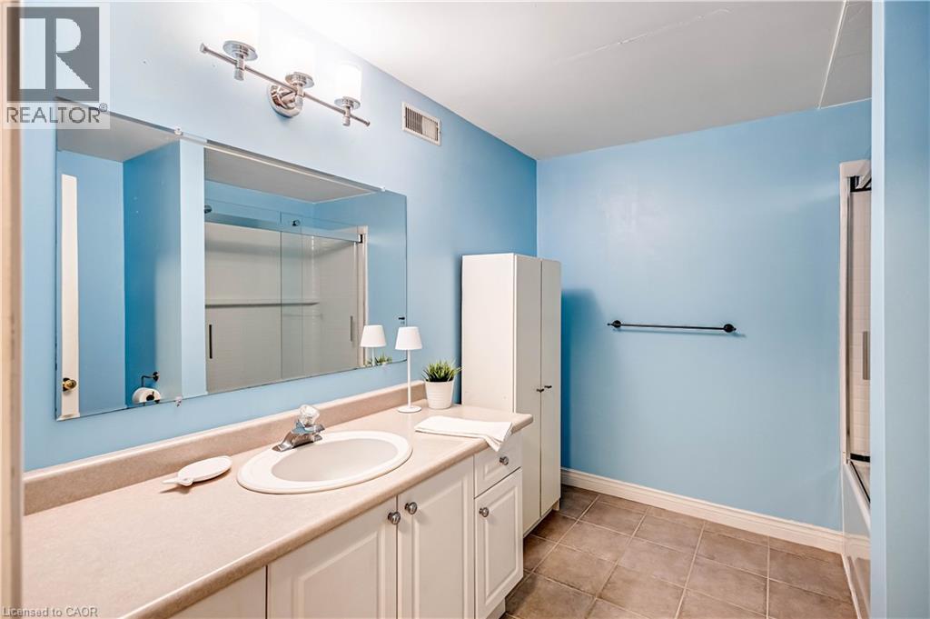 Bathroom featuring vanity and light tile patterned flooring - 65 Thistlemoor Drive, Caledonia, ON - Indoor Photo Showing Bathroom