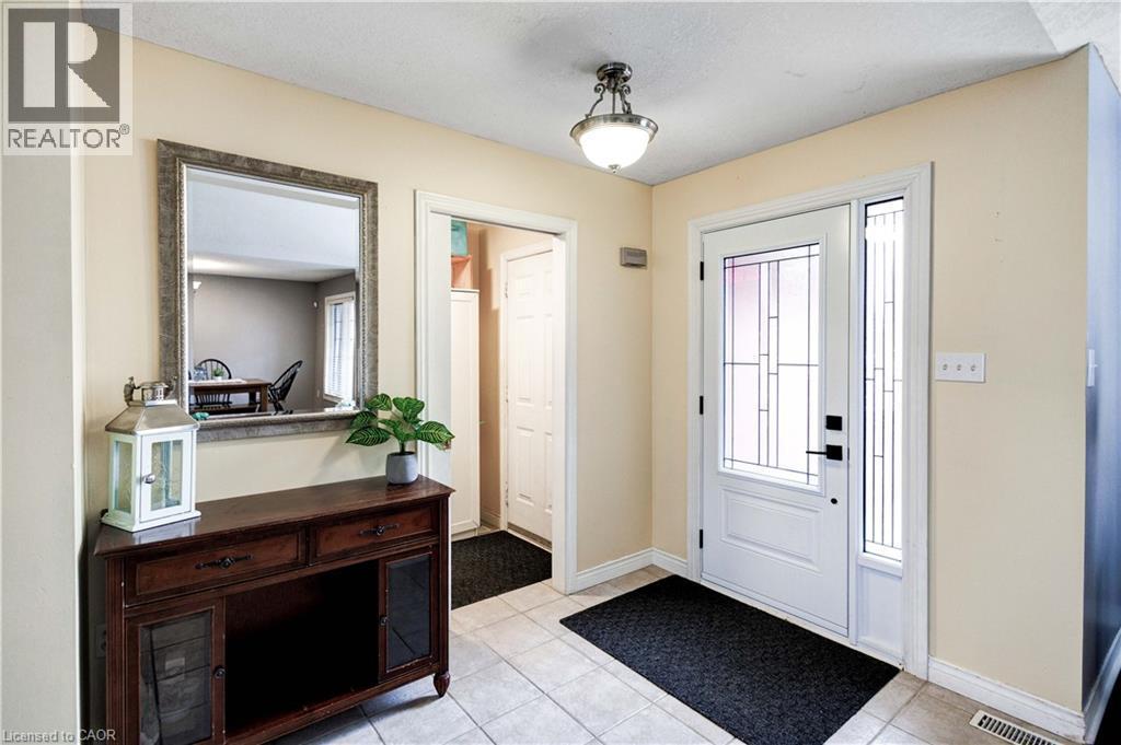 Entryway featuring light tile patterned flooring and plenty of natural light - 65 Thistlemoor Drive, Caledonia, ON - Indoor Photo Showing Other Room