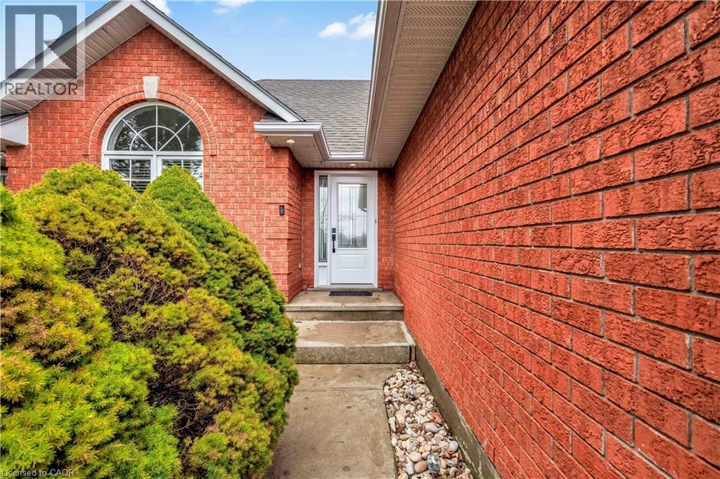 Entrance to property with brick siding and a shingled roof - 65 Thistlemoor Drive, Caledonia, ON - Outdoor