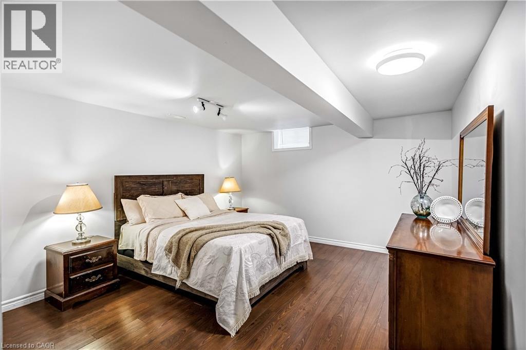 Bedroom with baseboards and dark wood finished floors - 65 Thistlemoor Drive, Caledonia, ON - Indoor Photo Showing Bedroom