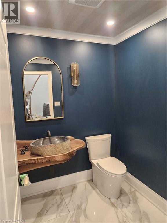 Bathroom with recessed lighting, vanity, ornamental molding, and light marble finish flooring - 2019 Dundas Street, Burlington, ON - Indoor Photo Showing Bathroom