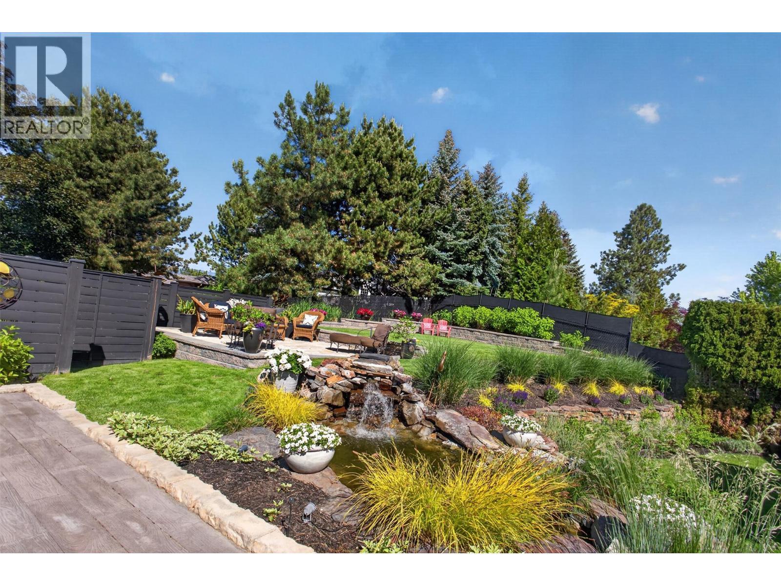 Featuring very impressive landscaping with a water feature **Image digitally enhanced to showcase the property's seasonal potential** - 336 Quilchena Drive, Kelowna, BC - Outdoor