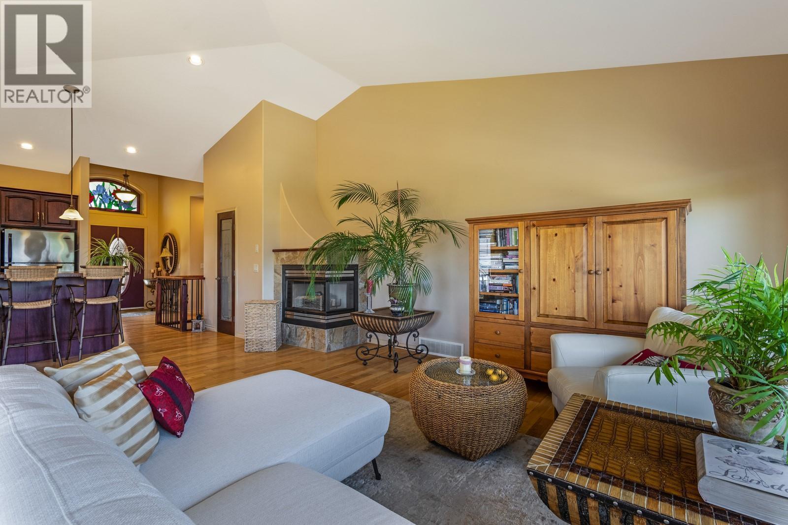 Vaulted ceilings throughout the living space - 610 Arrowleaf Lane, Kelowna, BC - Indoor Photo Showing Living Room With Fireplace