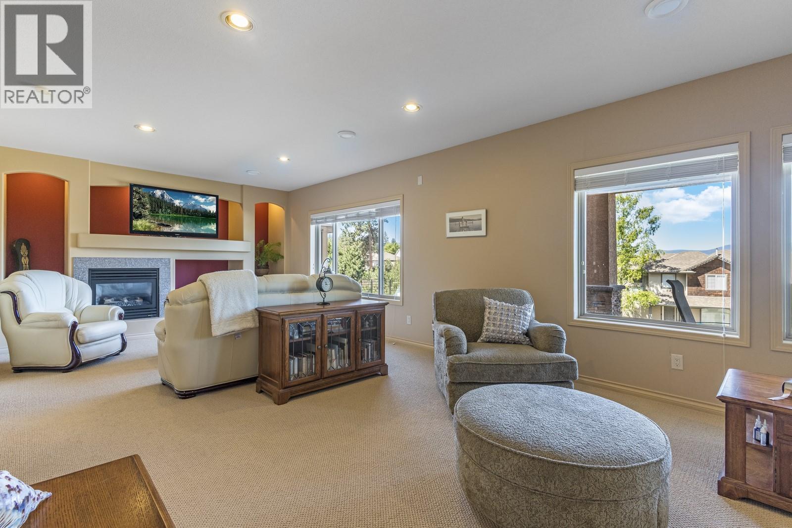 Lower level family room - 610 Arrowleaf Lane, Kelowna, BC - Indoor Photo Showing Living Room With Fireplace