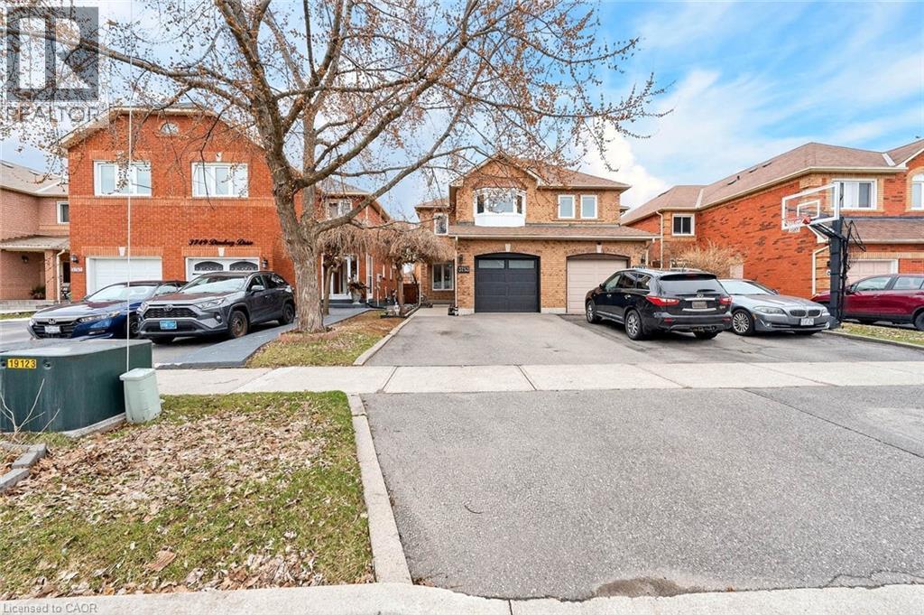 Traditional home featuring driveway, brick siding, and an attached garage - 3753 Densbury Drive, Mississauga, ON - Outdoor With Facade