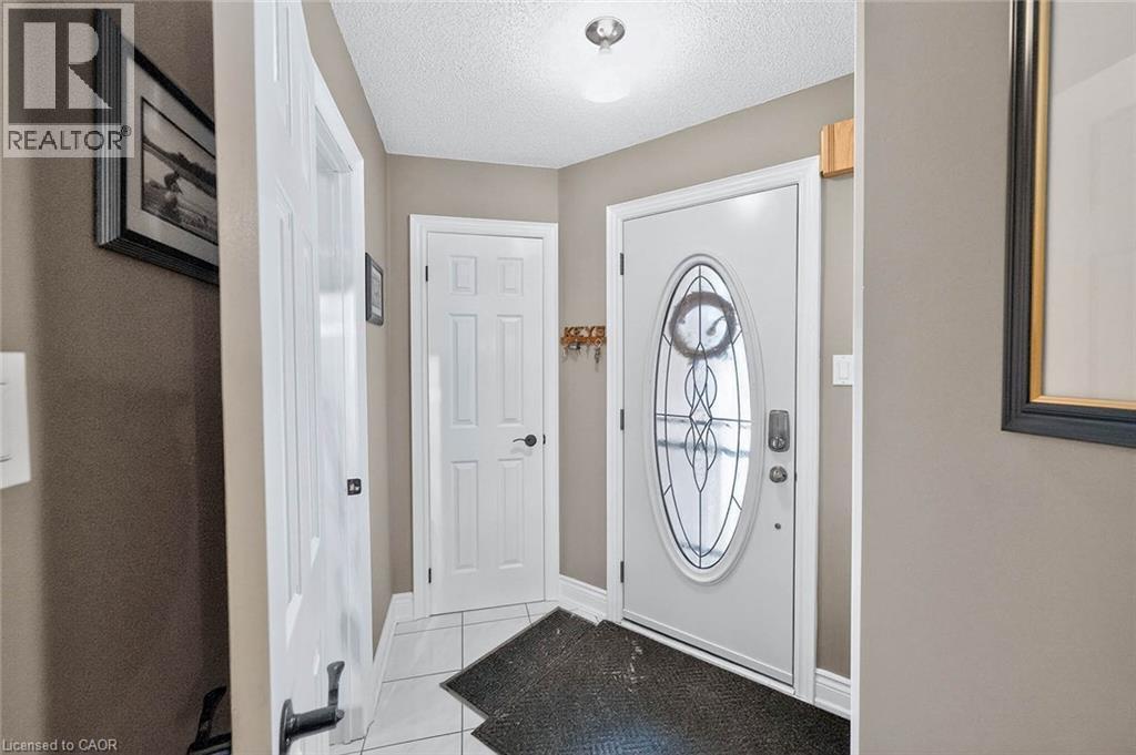 Foyer featuring light tile patterned flooring and a textured ceiling - 3753 Densbury Drive, Mississauga, ON - Indoor Photo Showing Other Room