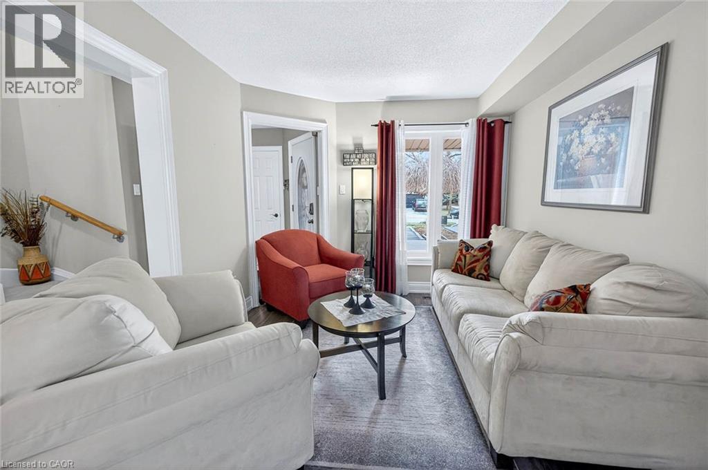 Living room featuring wood finished floors and a textured ceiling - 3753 Densbury Drive, Mississauga, ON - Indoor Photo Showing Living Room