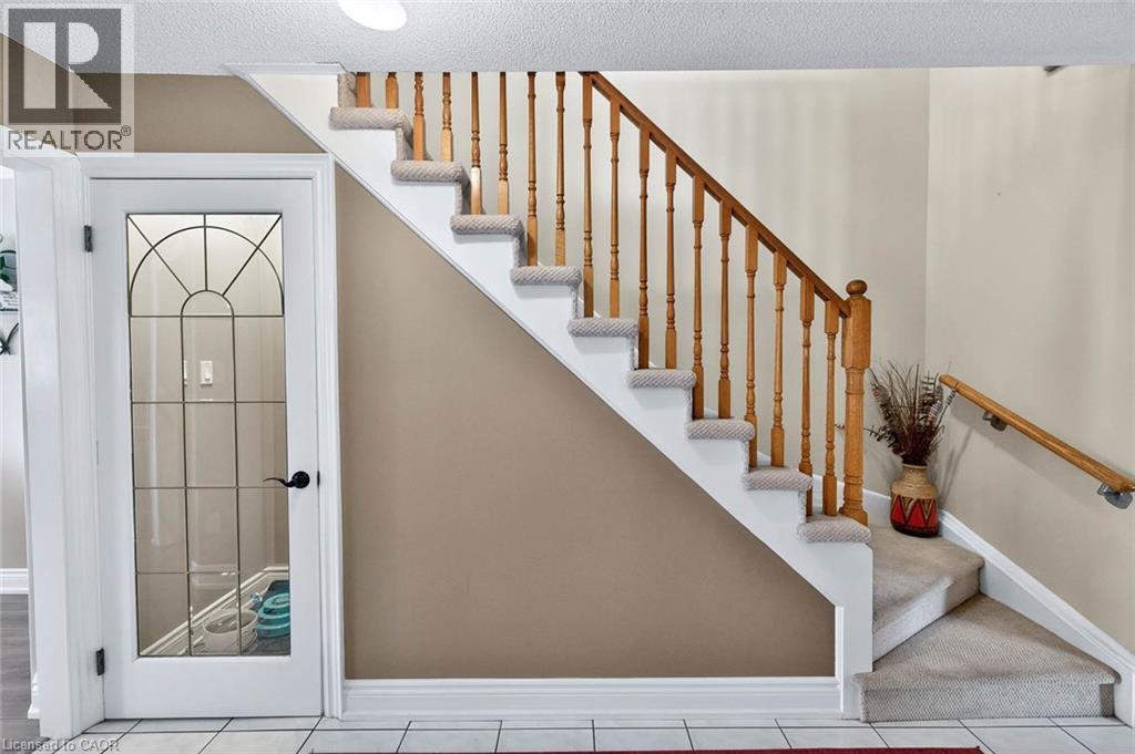Staircase with a textured ceiling and tile patterned flooring - 3753 Densbury Drive, Mississauga, ON - Indoor Photo Showing Other Room