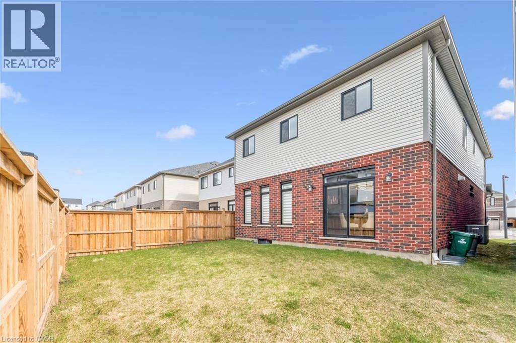 Back of property with brick siding, a fenced backyard, and a residential view - 628 Florencedale Crescent, Kitchener, ON - Outdoor With Exterior