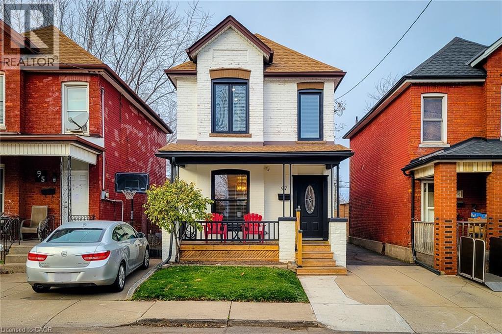 View of front facade featuring a porch, a shingled roof, and brick siding - 97 Keith Street, Hamilton, ON - Outdoor