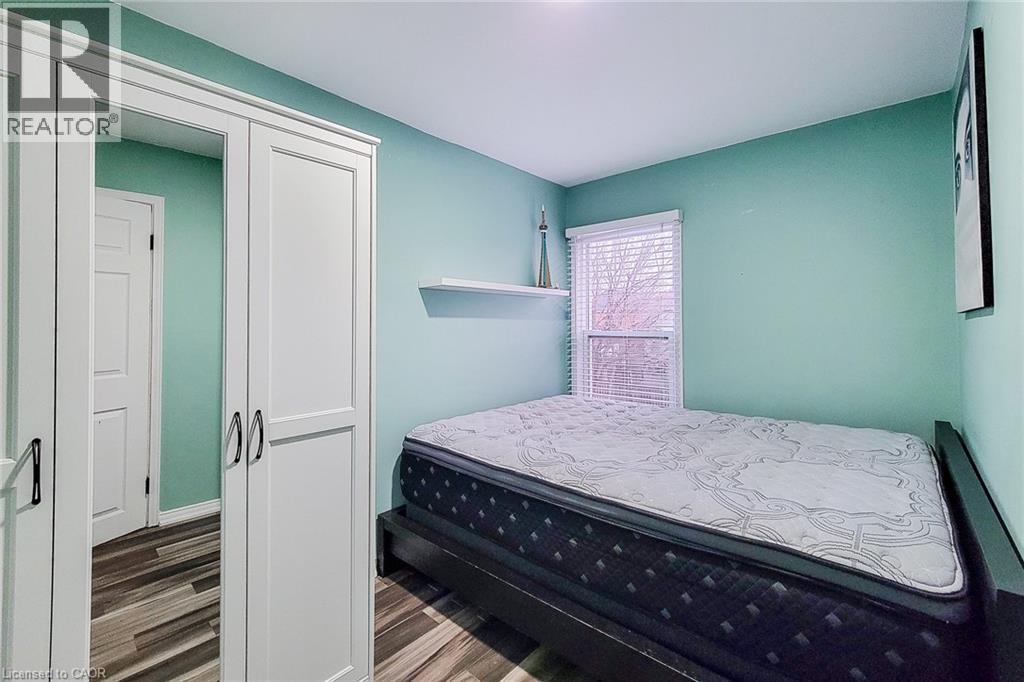 Bedroom with wood finished floors - 97 Keith Street, Hamilton, ON - Indoor Photo Showing Bedroom